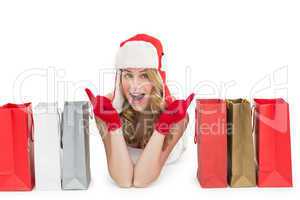 Happy woman lying between shopping bags
