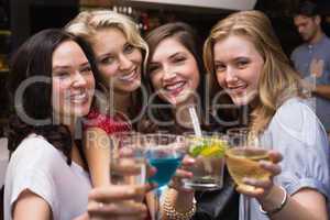 Pretty friends having a drink together