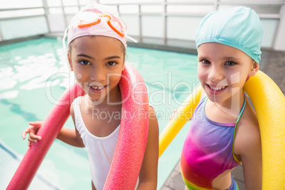 Cute little girls smiling poolside