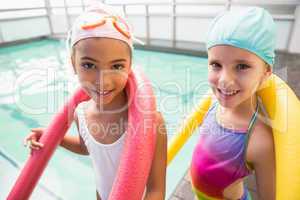 Cute little girls smiling poolside