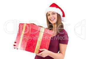Young woman in santa hat holding gift box