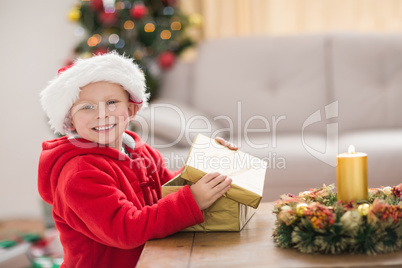 Festive little boy opening a gift