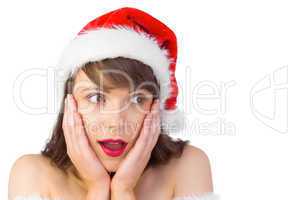 Pretty santa girl with hands on face