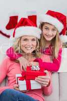 Festive mother and daughter with gifts