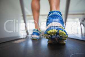 Low section of a man running on treadmill