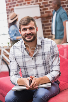 Portrait of casual man sitting on couch