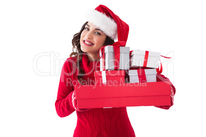 Festive brunette holding pile of gifts