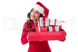 Festive brunette holding pile of gifts