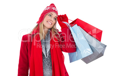 Blonde in winter clothes holding shopping bags