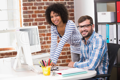 Photo editors using computer in office