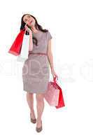 Happy brunette with shopping bags on the phone