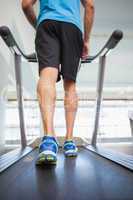 Low section of a man running on treadmill