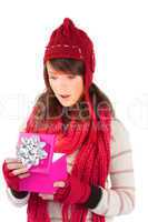 Festive brunette opening a gift