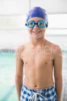 Cute little boy standing poolside