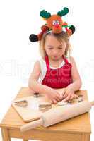Festive little girl making cookies