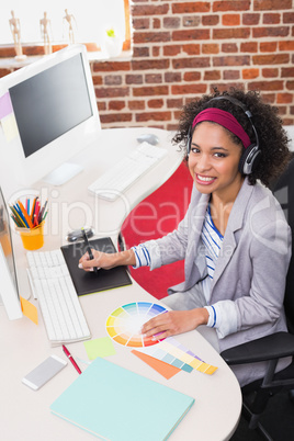Female photo editor using digitizer in office
