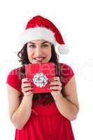 Festive brunette holding gift with bow
