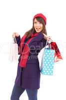 Young woman in winter clothes posing with shopping bags