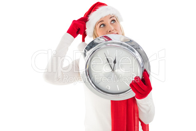 Festive blonde holding a clock