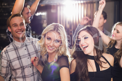 Stylish friends dancing and smiling