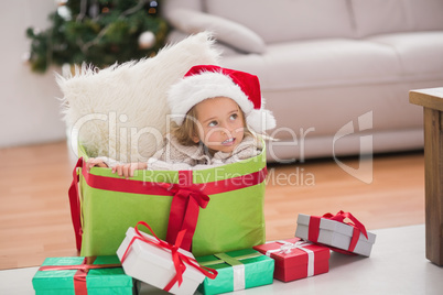 Cute little girl sitting in giant christmas gift