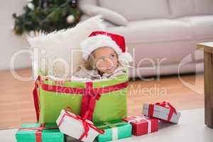 Cute little girl sitting in giant christmas gift