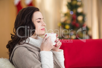 Brunette enjoying a hot chocolate at christmas