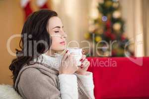 Brunette enjoying a hot chocolate at christmas