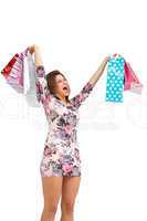 Excited brunette holding up shopping bags