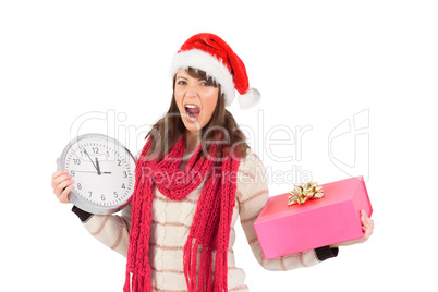 Yelling brunette holding a clock and gift