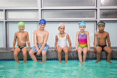 Cute swimming class smiling at camera