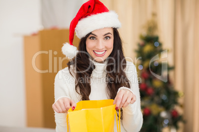 Festive brunette opening gift bag