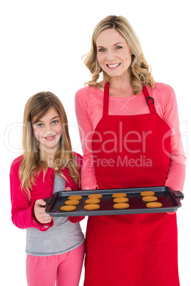 Festive mother and daughter making christmas cookies