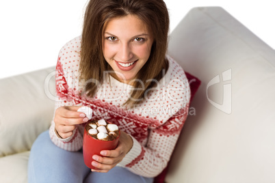 Woman enjoy her coffee sitting on the sofa