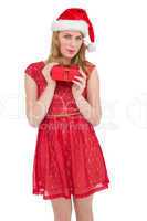 Blonde woman in santa hat standing with gift