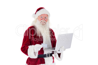 Santa pays with credit card on a laptop