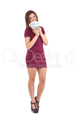 Pretty blonde in burgundy dress showing her cash