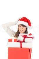 Attractive santa woman scratching head and holding gifts