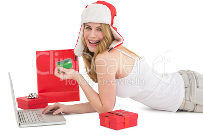 Happy woman shopping online lying on the floor