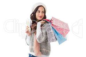 Brunette holding cash and shopping bags