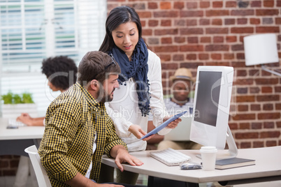 Creative people looking at digital tablet