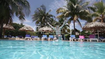 Teenager floats under water in pool