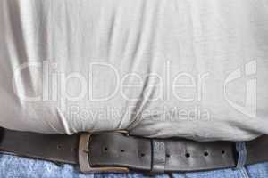 Detail view of belt in blue jeans