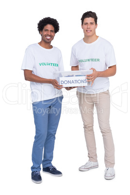 Young smiling volunteers collecting donations