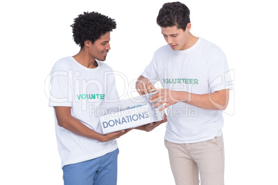 Young smiling volunteers collecting donations