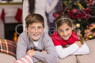 Brother and sister leaning on the couch