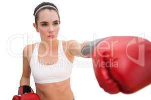 Fit brunette in boxing gloves