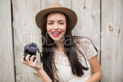 Pretty brunette holding her camera