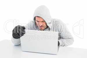 Hacker using laptop to steal identity