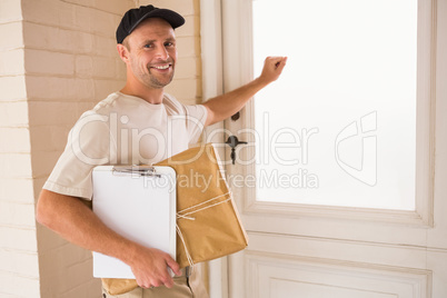 Smiling handyman knocking at the door